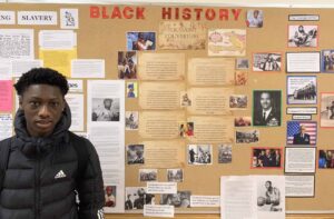 Gabe Dedu with his exhibit for Black History Month